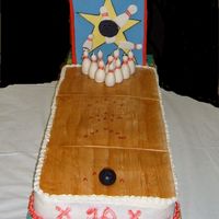 Bowling Alley Cake 2 9x 13, end to end. One french vanilla, one strawberry. Buttercream icing. Fondant "alley" and sign. Fondant pins wrapped around...