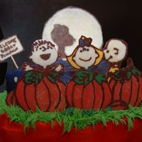 It's The Great Pumpkin Cake, Charlie Brown! The characters are made from candy melts and stand up in the cake, which gives it a really nice 3D look that doesn't come through well...
