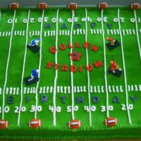 Football Field This is a sheet cake frosted in buttercream with fondant accents. The name of the stadium is named after the birthday boy