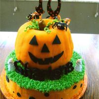 Pumpkin Cake Bottom cake is covered in buttercream with fondant accents. The pumpkin is two bundt cakes put together covered in fondant.