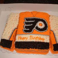 Flyers Jersey Made from 2 sheet cakes, layered and cut. Transfered the logo using the image/piping gel method. My nephew loved it!