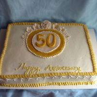 Golden Anniversary Carrot cake with cream cheese buttercream. Gumpaste flowers. My freehand writing needs some work, as does my icing technique - it was a...