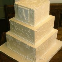 Lacey Square All Swiss buttercream with royal icing details. Top and bottom tiers were white with raspberry bc filling. Middle tier was chocolate mocha...
