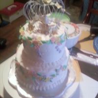 My 1St Wedding Cake: Love Birds Two-layer cake with butter cream icing with gumpaste flowers (daisies, pansy, buttercups)
