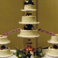 7 Teir With Fountain white cake with raspberry filling iced with buttercream still learning amazing what one can learn off the internet