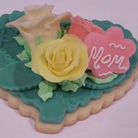 Roses With Heart Buttery cookie covered with chocolate fondant and decorated with chocolate plastic roses.