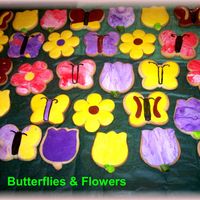 Butterflies__Flowers.jpg simple butterflies and flowers done last minute for my daughters b'day at shcool. Cookies are covered in fondant. TFL