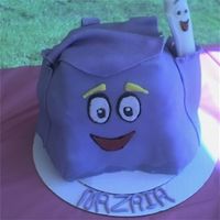 Backpack From Dora The Explorer Yellow cake with BC. To save time, I just baked one 14" square , cut it into fourths and stacked. Used Rice krispies to fill out sides...