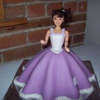 Daughters Third Birthday Cake. My daughters wanted princess cakes so I made them each a princess with a dress in the colour of their choice.