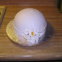 First Communion 8 inch chocolate bomb cake that is filled with chocolate fudge mousse and covered in white fondant and gumpaste flowers (that I purchased...