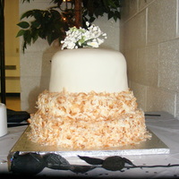 60Th Birthday Party 3 tiered, almond cake with coconut mousse filling. Bottom 2 tiers are are decorated with buttercreme and toasted, shaved coconut. Top tier...