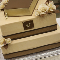 Bible Anniversary Cake All buttercream, except for bible, covered with chocolate fondant. Gumpaste flowers.