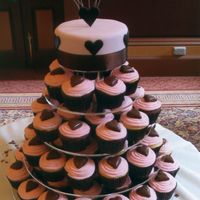 Wedding Cake Chocolate and vanilla cupcakes with mud cake on top tier covered in fondant and hearts.