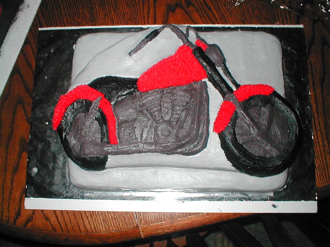 Motor Cycle Graduation Cake This is a cake I made for a graduate. It is chocolate and white cake with bc frosting. It is 2 layers. Fun to make.