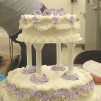 Course 3 Final Cake Iced in buttercream with buttercream piping and royal flowers.