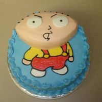 Stewie Cake 10" white cake filled with whipped cream and strawberries, iced in buttercream. The head is just carved cake, also iced in buttercream...