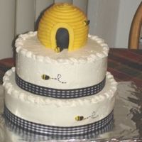 Cc.jpg 8" and 10" chocolate cakes with whipped chocolate filling. Topped with a beehive covered in fondant...bees also made of fondant...