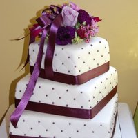 Ann's Wedding Cake Had a lot of trouble with the cake crumbling, but in the end, it turned out ok. Aubergine (eggplant) ribbon and dots. TFL