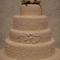 Winter Wedding 4 teir ivory fondant wedding cake. Decorated with piped scroll work.when cut into all you saw was the beautiful red velvet cake.