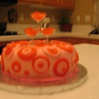 Pink Champagne Cake Covered with fondant and wine glass favors on the top with rock candy
