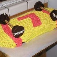 Skateboard Cake this was for my sons 7th bday. I used 1 round cake cut in half for the ends and a rectangular cake with the sides cut out. the "trecks...
