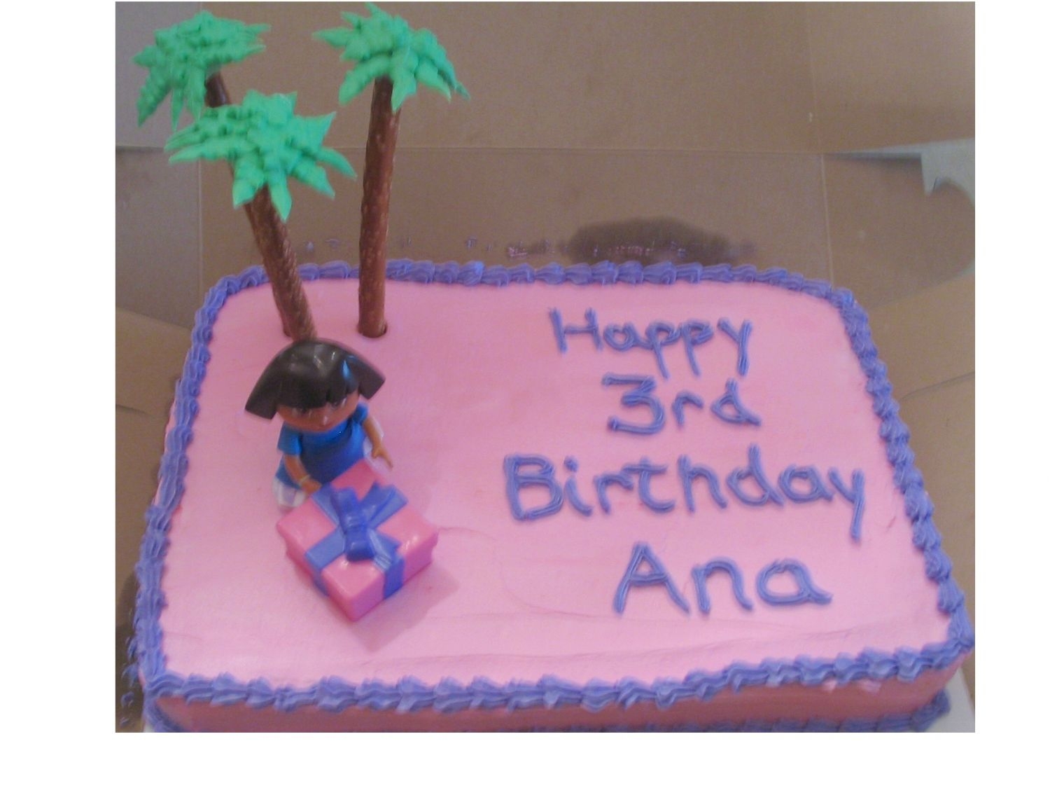 Dora Birthday Cake Chocolate cake with buttercream frosting. Palm trees made of pretzel rods & buttercream leaves.