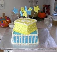 Yellow And Blue Baby Shower Two tiered yellow cake with buttercream frosting