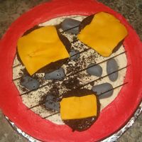 Grillin Out hamburger with cheesse on grill,every thing is fondant ,grill is spaghaiirolled in brown food coloring , hamburgers are fondant with...