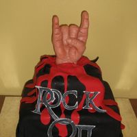 Rock On I made this for a boys 16 birthday. The hand is made of molding choclate and then airbrushed.