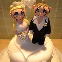 Valentines Day Wedding Cake This is a two tier chocolate and caramel mud cake with buttercream frosting and the figurines are made of sugarpaste