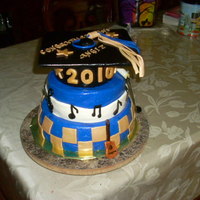 High School Graduation Cake This cake was for a customer who is musically gifted so naturally a muscial graduation cake was my thought. Red velvet cake top tier,...