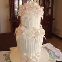 Daniella's Cake I made this cake for my cousin whose wedding is in two weeks, the cake is fruit and the flowers are sugar paste. Would love any...