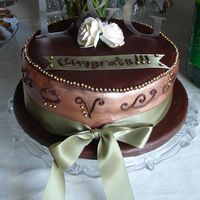 October_Engagement_2007_001A.jpg Engagement Party Cake Chocolate fondant with chocolate & vanilla cake w/ raspberry filling The letters are metal monograms...