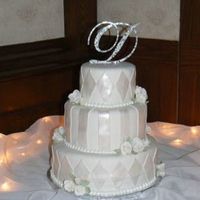 Wedding Cake This cake is covered in fondant and then decorated with fondant painted with pearl dust.