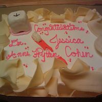 Dentist's Dream Cake i made a tooth out of rice krispies and covered it in fondant, there is shaved white chocolate on this cake around the edges also...