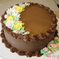 Chocolate & Flowers Iced in chocolate BC and decorated with royal flowers.