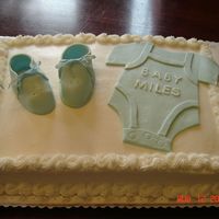 Booties & Onesie Cake decorated in BC. Booties and onesie were gumpaste.
