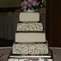 Scroll Square Wedding Wedding cake covered in MMF, BC scrolls, fabric ribbon and the fresh flowers were prepared by the florist. Thank you for looking.