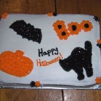 Happy Halloween Orange (yellow) cake with buttercream frosting and decorations.