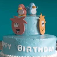 Club Penguin Cake my first tiered cake, first time using IMBC. first time making fondant figures, first time using gumpaste (for the puffles on the sides)...