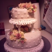 Course Iii Wedding Cake Chocolate Bottom tier, strawberry top tier. Fondant roses in peach, yellow and dusty rose.