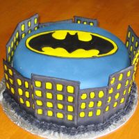 Batman/gotham City Cake Made this for a preteen boy who loves Batman! Chocolate cake covered in fondant. Buildings and Batman symbol are royal icing transfers....