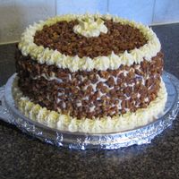 White Chocolate Praline Crunch Cake 4 layers of pecan cake, brushed with brandy simple syrup. Frosted and filled with white chocolate cream cheese frosting. Covered with...