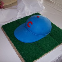 Cubs Baseball Cap Chocolate cake (I cut it horizontally and put buttercream between the "layers". Covered a foam sun visor with royal blue fondant...
