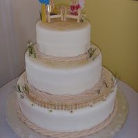 Beach Wedding Cake Fondant covered 3 tier wedding cake. We used cinnamon and sugar for the "sand", colored fondant for the rope and got the beach...