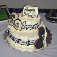 30Th Birthday Chocolate cake on the bottom and white cake on the top. Butter cream all around with fondant surrounding the wall of cakes.