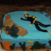 Scuba Diver Birthday cake for a friend who is getting her diving certification. Scuba diver was easier than I thought it would be. Added the shark fins...