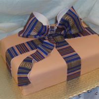 College Graduation Cake A college graduation cake with an afro-centric theme. The Kente cloth Bow is Gumpaste.