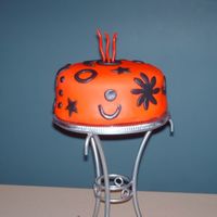 Contemporary Red Birthday Cake Red fondant covered German chocolate cake with shapes cut out of black fondant.