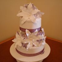 Mauve Lilly Wedding Cake This cake was a 15cm and 20cm caramel mud cake covered in caramel frosting and fondant icing. The lilies and filler flowers were made from...